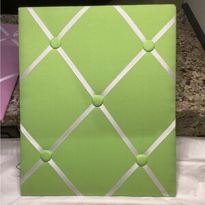 Green Memo Board fabric picture holder with crisscross ribbon, 14” x 17”.